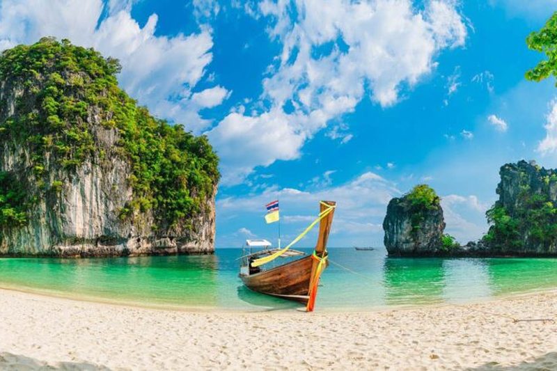 Tropical beach with longtail boat in Thailand